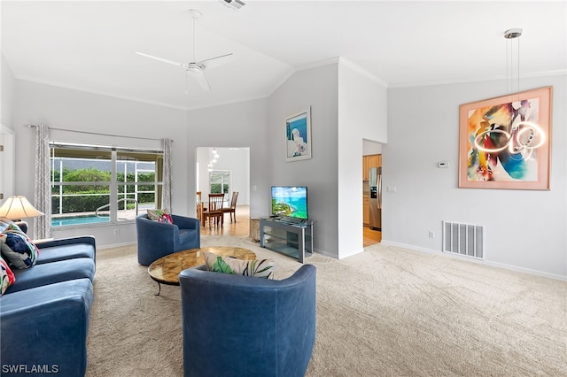 carpeted living room with lofted ceiling, ceiling fan, and ornamental molding