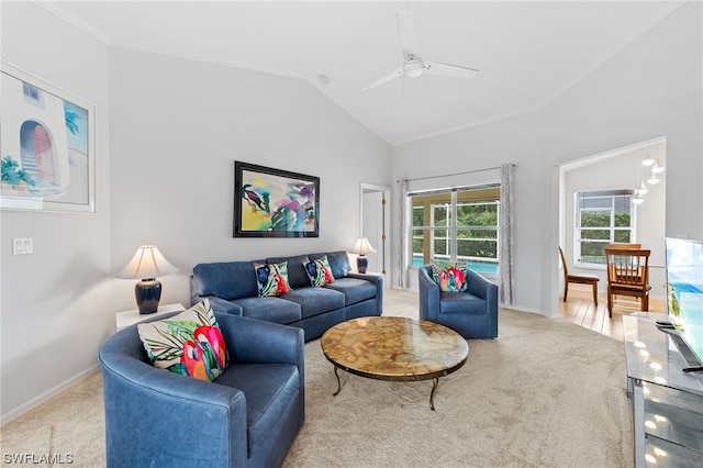 living room with light carpet, crown molding, lofted ceiling, and ceiling fan with notable chandelier