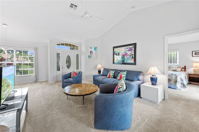 carpeted living room with vaulted ceiling, ceiling fan, and crown molding