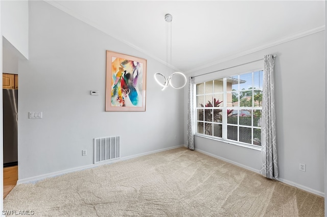 empty room with light carpet, vaulted ceiling, and ornamental molding