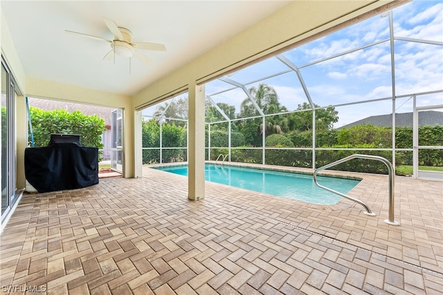 view of pool featuring a grill, ceiling fan, a patio, and a lanai