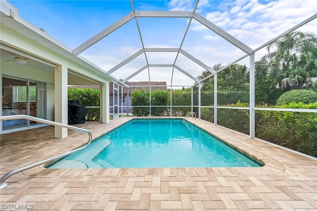 view of pool with a patio area and a lanai