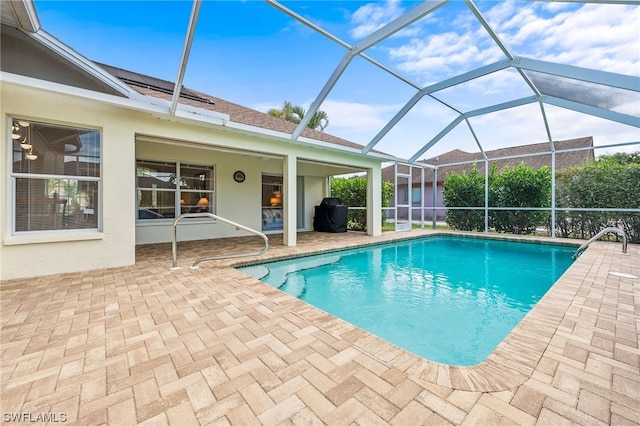 view of pool featuring a lanai and a patio