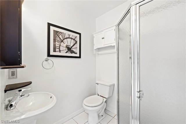 bathroom featuring tile patterned flooring, sink, an enclosed shower, and toilet