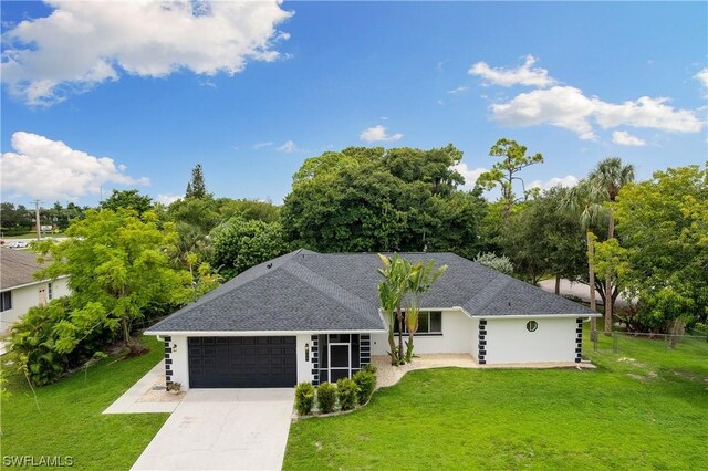 single story home featuring a front lawn and a garage