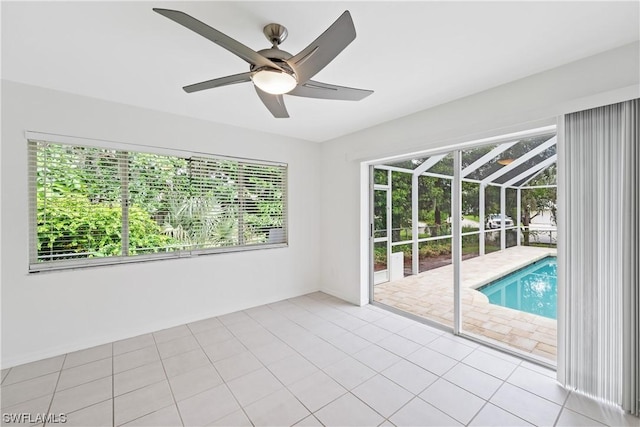 spare room with light tile patterned floors and ceiling fan