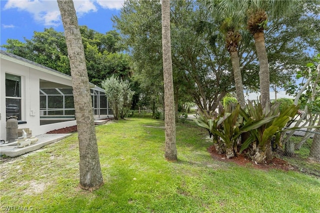 view of yard with glass enclosure