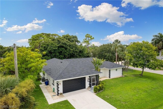 view of front of house featuring a garage and a front lawn