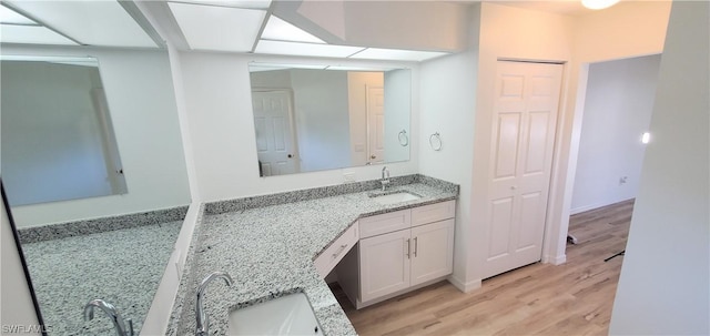 bathroom featuring hardwood / wood-style flooring and vanity