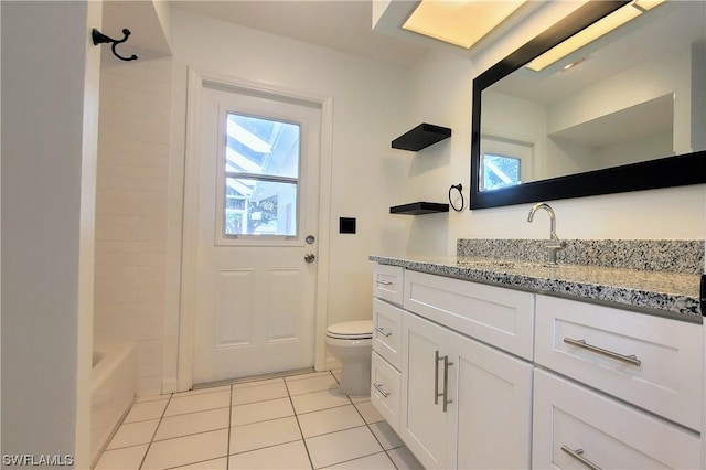 full bathroom with vanity, tile patterned floors, toilet, and a healthy amount of sunlight