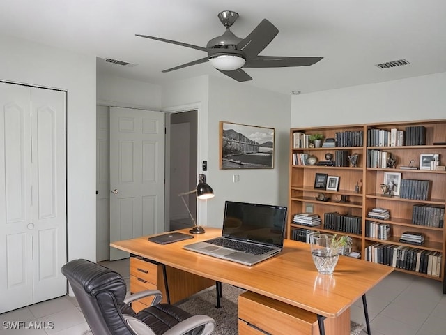 tiled office featuring ceiling fan