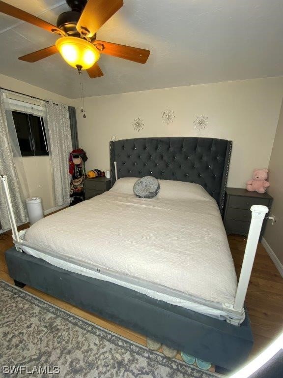 bedroom featuring ceiling fan and hardwood / wood-style floors