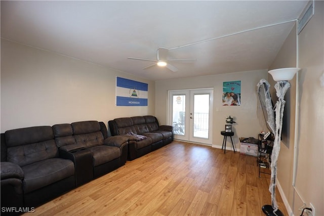 living room with ceiling fan, french doors, and light hardwood / wood-style floors