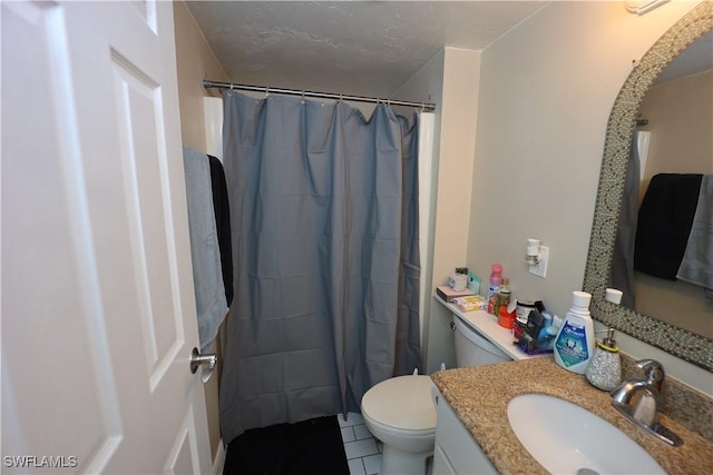 bathroom with tile patterned flooring, vanity, toilet, and a textured ceiling