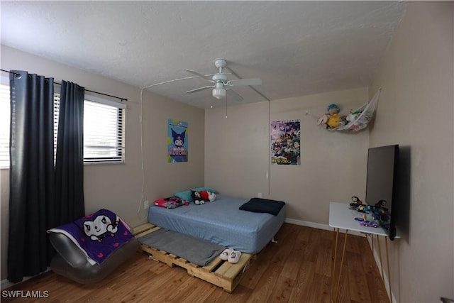 bedroom with hardwood / wood-style floors and ceiling fan