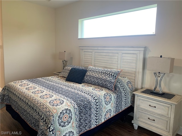 bedroom with dark wood-type flooring