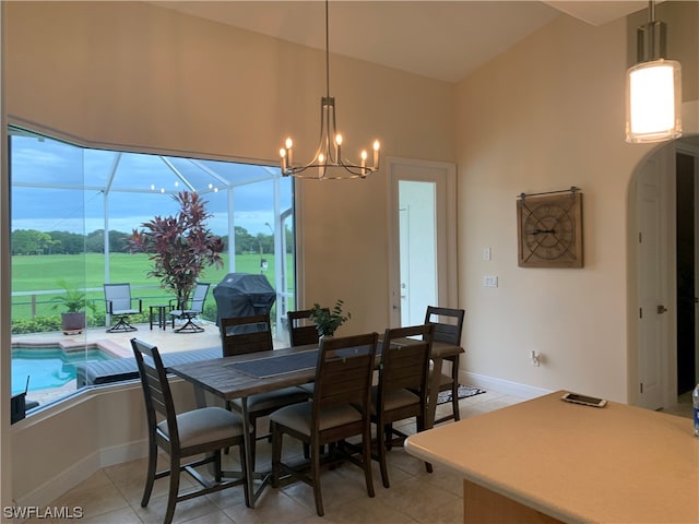 dining room with a notable chandelier and light tile floors