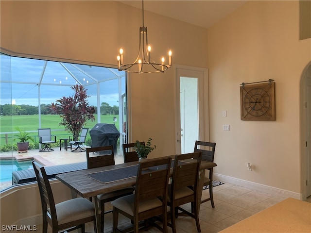 dining area featuring light tile floors, plenty of natural light, and a chandelier