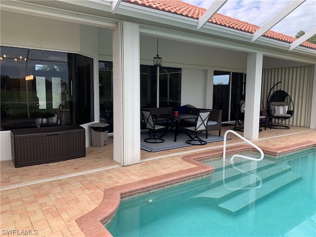 view of pool with a patio and glass enclosure