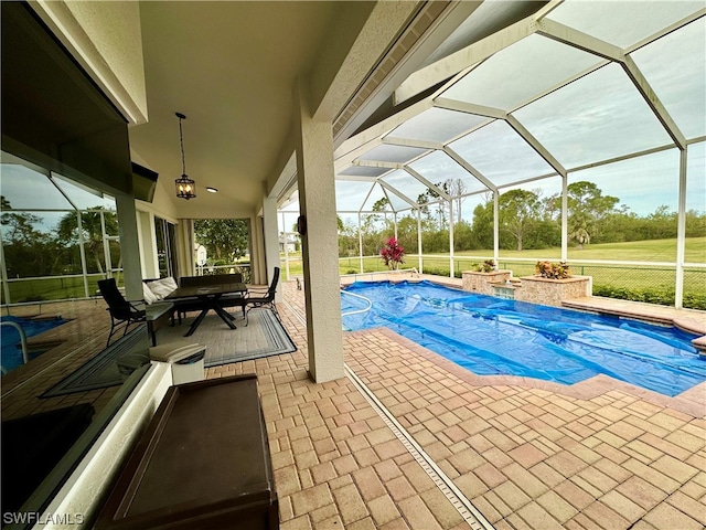 view of swimming pool featuring a patio and a lanai