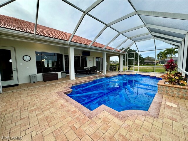 view of pool featuring a lanai and a patio area