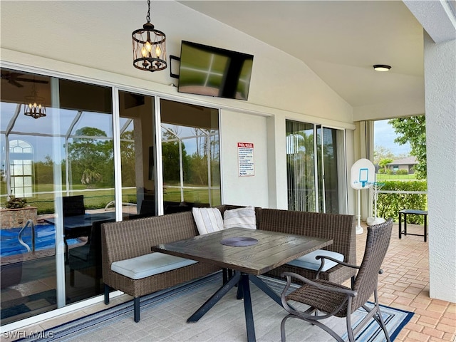 exterior space with a notable chandelier and lofted ceiling