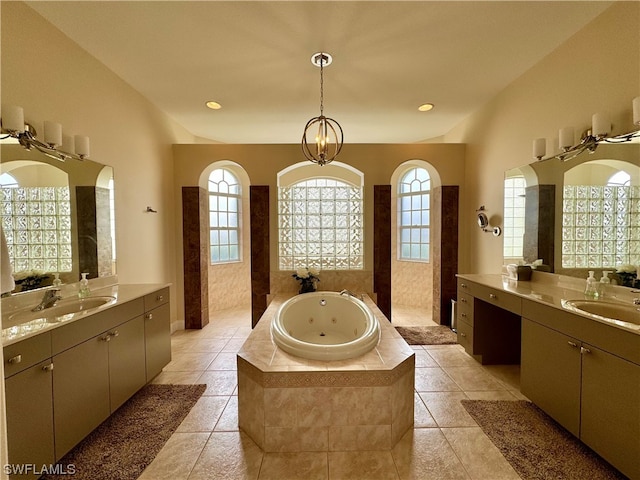 bathroom featuring double sink vanity, tile floors, a notable chandelier, and tiled tub