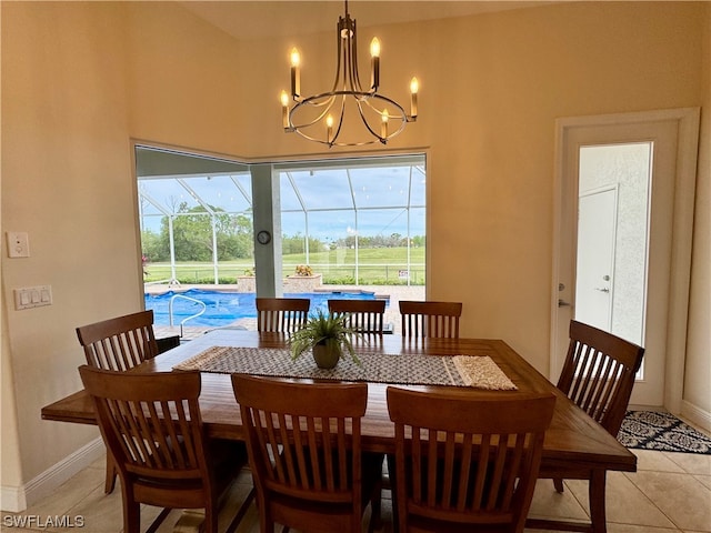 tiled dining room featuring an inviting chandelier