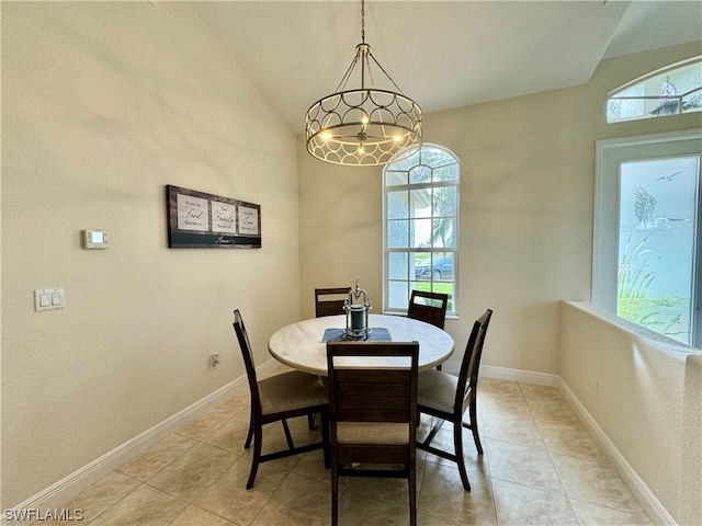 tiled dining area with an inviting chandelier and lofted ceiling