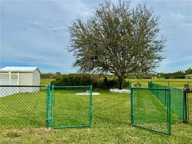 view of gate featuring a lawn