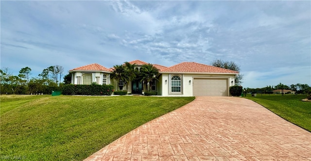 mediterranean / spanish-style home with a front lawn and a garage