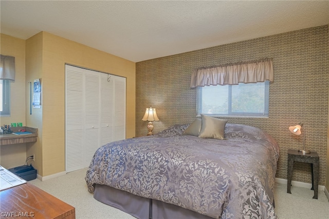 bedroom featuring a closet and light colored carpet