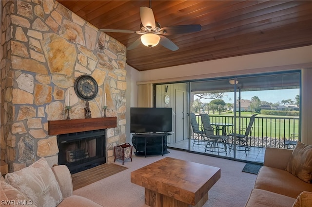 carpeted living room featuring a stone fireplace, ceiling fan, and wood ceiling