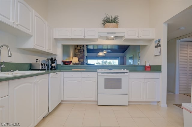 kitchen with white cabinets, light tile floors, white appliances, and sink