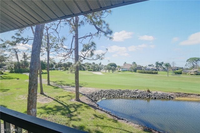 view of home's community with a water view and a yard