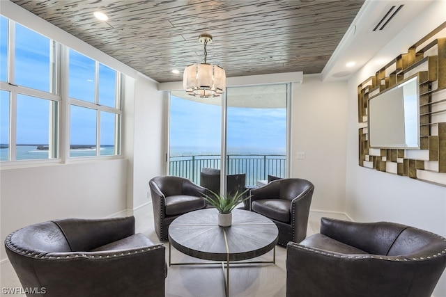 living room featuring a water view and wood ceiling