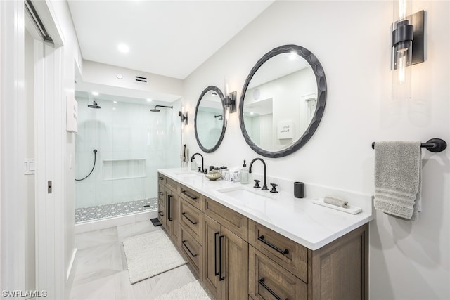 bathroom featuring vanity with extensive cabinet space, tile flooring, double sink, and tiled shower