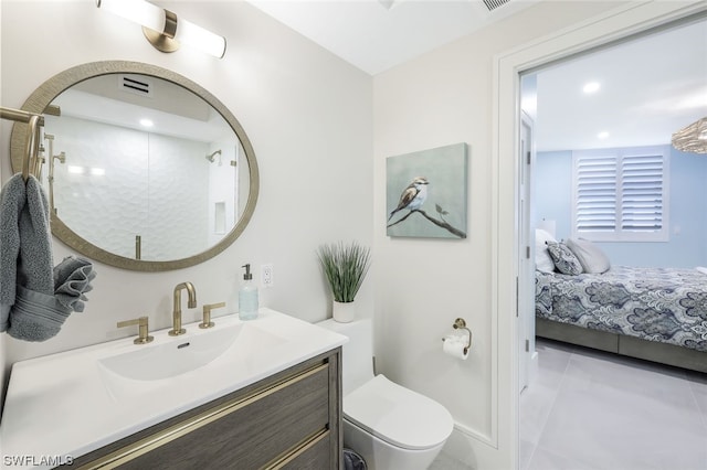 bathroom with toilet, tile floors, and oversized vanity