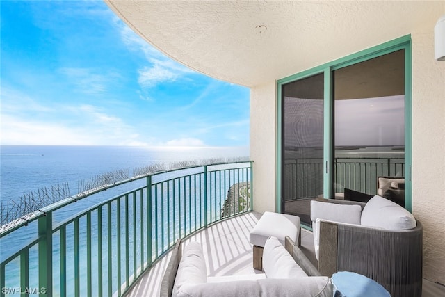 balcony with a water view and an outdoor hangout area