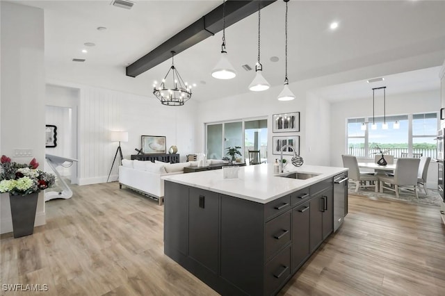 42231 Lake Timber Dr, Punta Gorda, FL 33982 - kitchen featuring beam ceiling, light countertops, light wood finished floors, a chandelier, and open floor plan