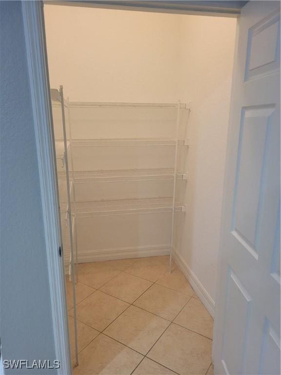 walk in closet featuring light tile patterned flooring