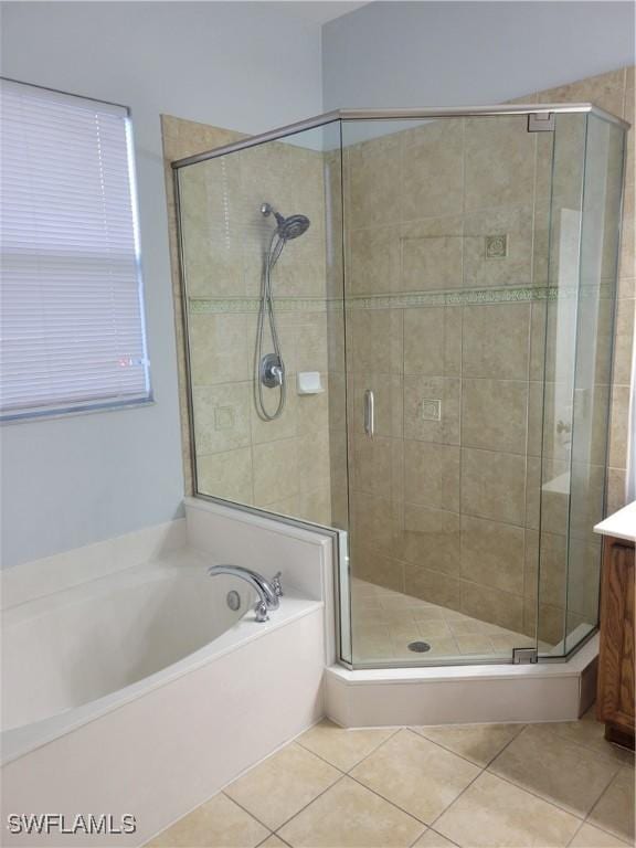 bathroom with tile patterned floors, vanity, and plus walk in shower