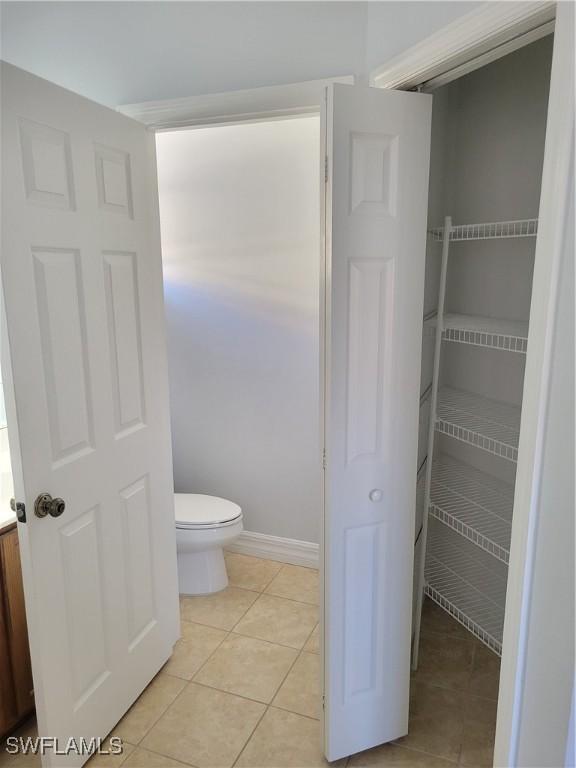 bathroom with tile patterned flooring and toilet