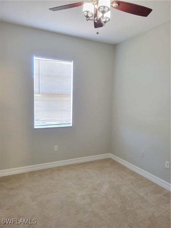 empty room featuring light carpet and ceiling fan