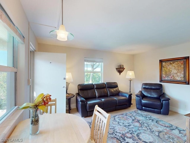 living room with a chandelier and light hardwood / wood-style flooring