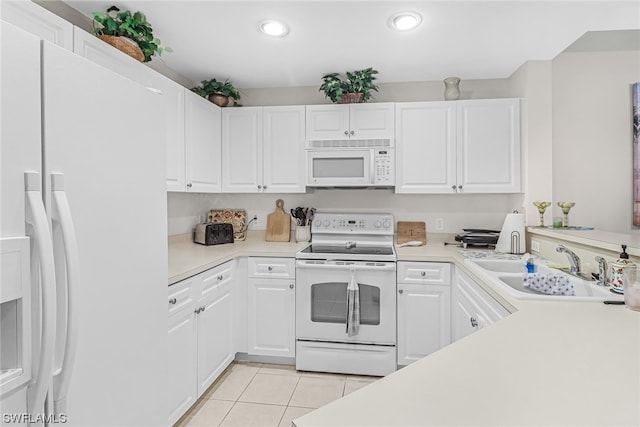 kitchen featuring white appliances, light tile patterned floors, light countertops, white cabinetry, and a sink