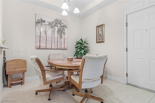 dining room featuring a chandelier, light tile patterned flooring, and baseboards