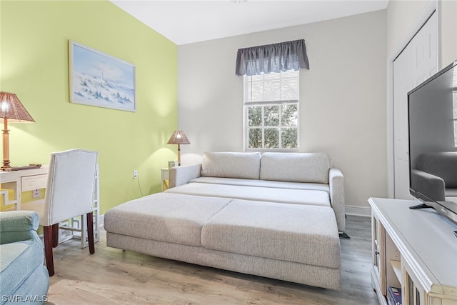 bedroom with baseboards and wood finished floors