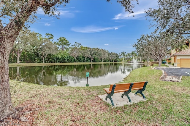 view of community with a water view and a lawn