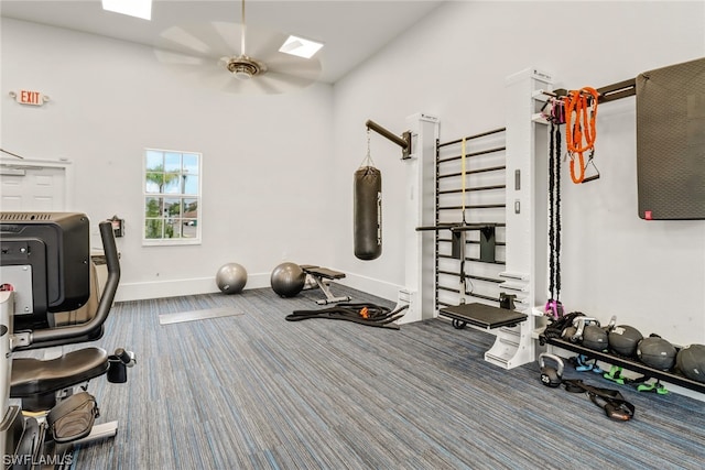 workout area with a ceiling fan, carpet, and baseboards